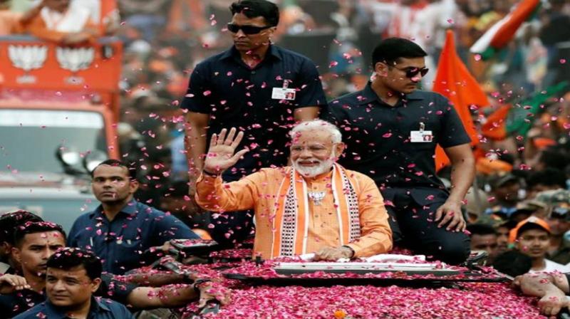 Modi showers flowers back on crowd during road show in Karnataka