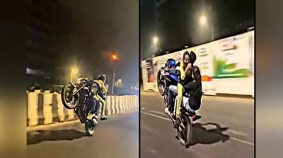 The young man was doing stunts by making two girls sit on the bike